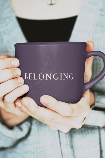 Woman holds a purple mug that says "belonging" a Grit Into Grace brand value